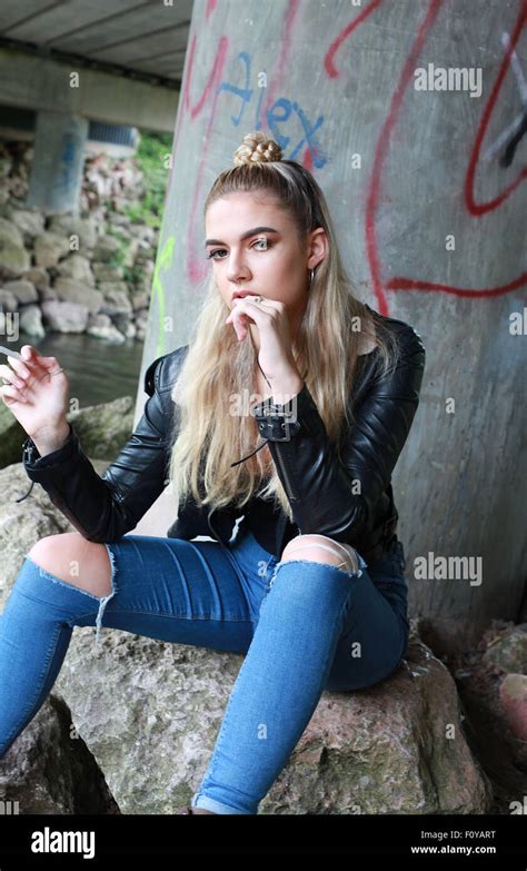 Tough Looking Teenage Girl With Her Nose Pierced Smoking A Cigarette