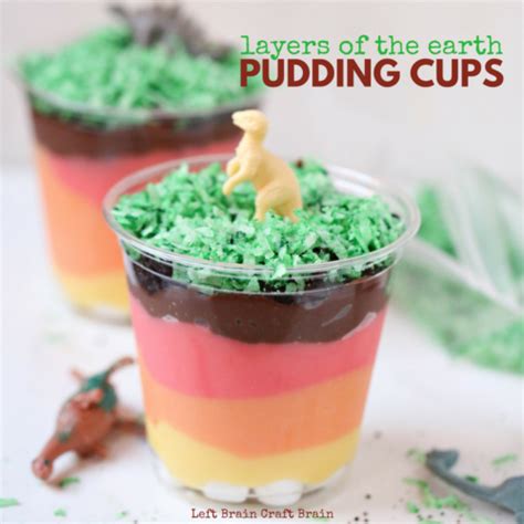 Two Dessert Cups Filled With Green And Red Frosting Topped With A Toy