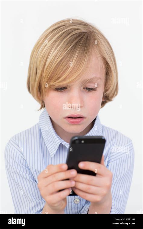 7 Year Old Boy Playing With A Smartphone Stock Photo Alamy