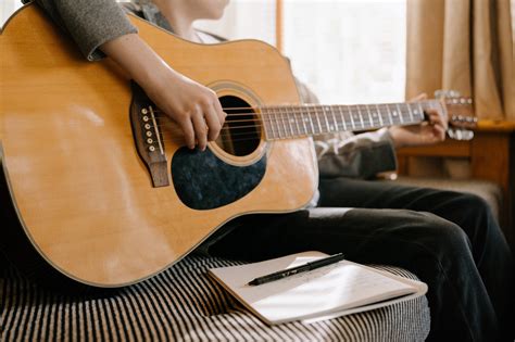 Person Playing Brown Acoustic Guitar · Free Stock Photo