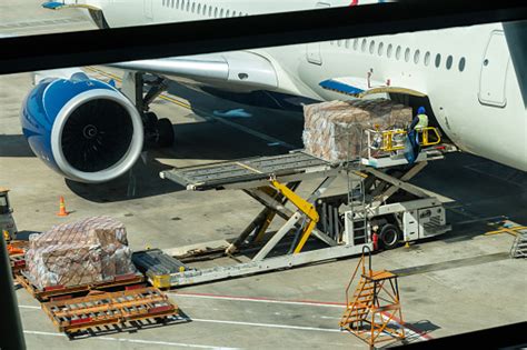 Scene Of Loading Luggage And Cargo To Airplane With Handling Operations
