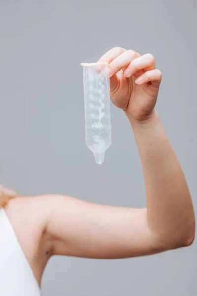 Female Hand Holding Condom Close Up On Grey Background Stock Photo By Smeilov