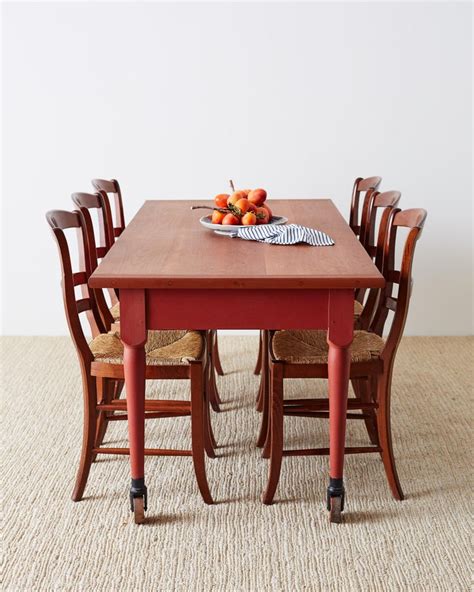 This decor style is very comfortable and homey, and farmhouse dining tables often feature natural wood or distressed paint, as well as spindle legs or trestles. Painted American Farmhouse Style Dining Table on Casters For Sale at 1stdibs