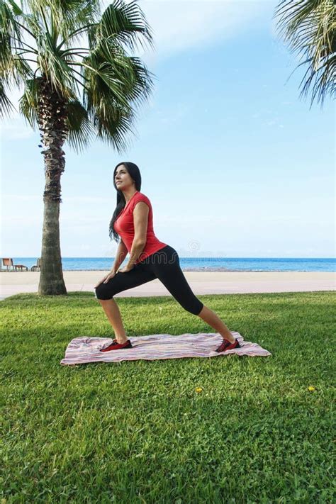 Woman Workout Sport Exercises Squat Outdoors On The Beach Stock Image