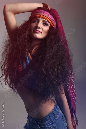 Young Hippie Girl With Long Brown Curly Hair Wearing Colorful Scarf