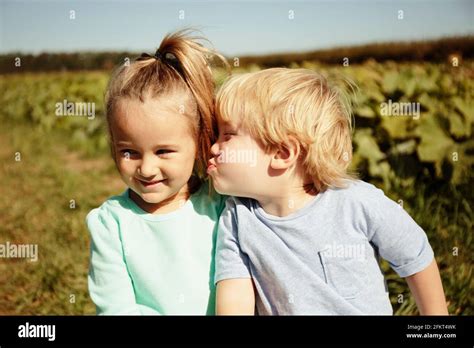 Boy Kissing Girl On Cheek Stock Photo Alamy