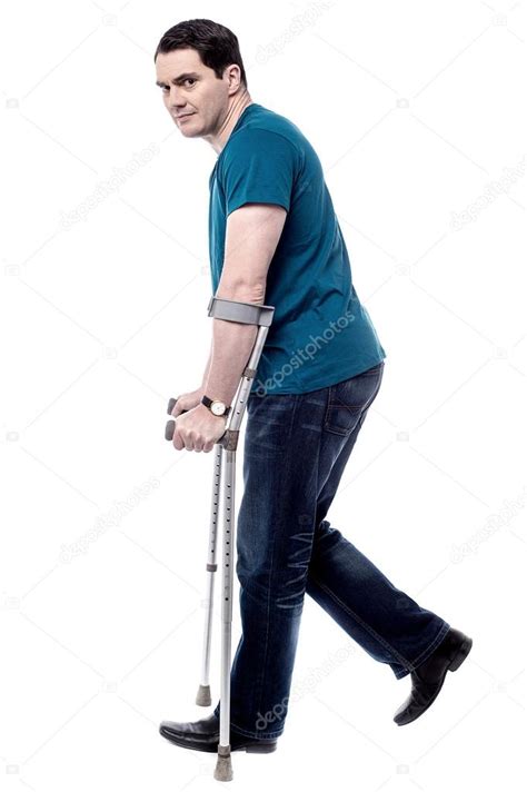 Man Walking With Crutches Stock Photo By ©stockyimages 71409587