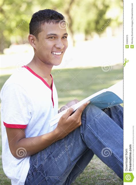 Teenage Boy Sitting In Park Reading Stock Image Image Of Reading