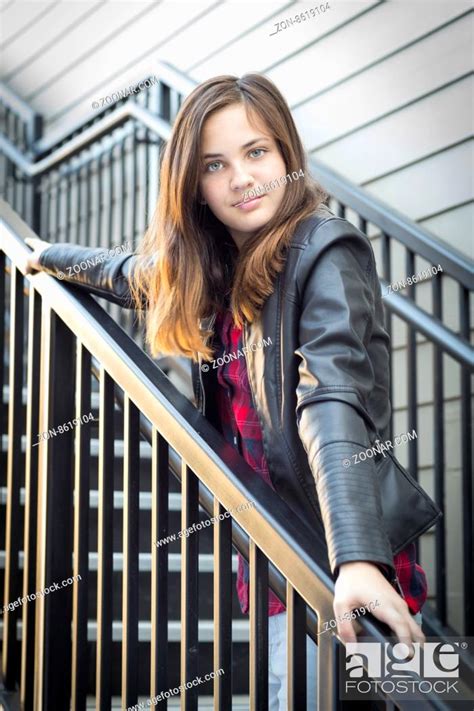Portrait Of Pretty Young Girl Weather Leather Jacket On Staircase
