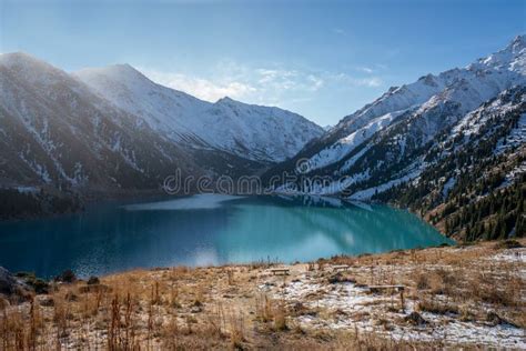 Beautiful Turquoise Lake Surrounded By Snowy Mountains On A Sunny Day