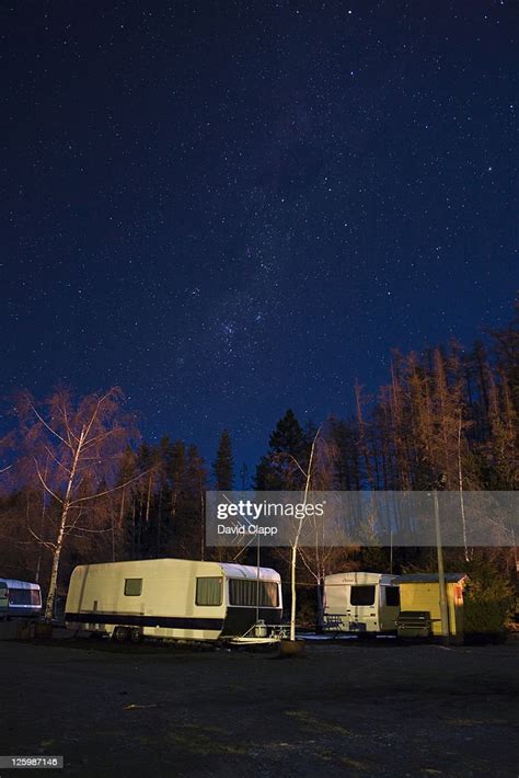 Starry Night Showing The Milky Way Over Caravan Park On Shore Of Lake