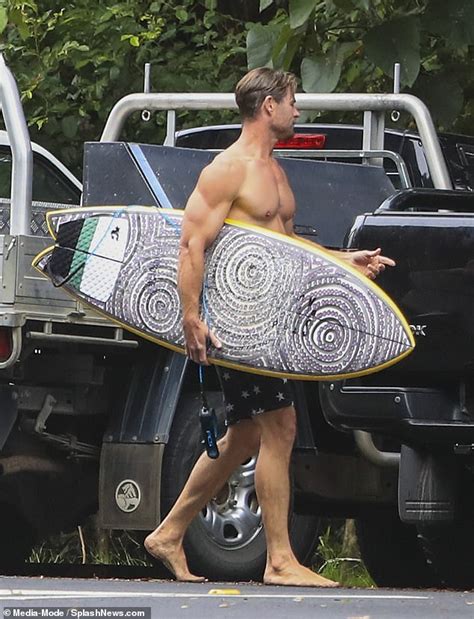 Chris Hemsworth Flaunts Physique While Surfing In Star Spangled Swim Trunks At Byron Bay Beach