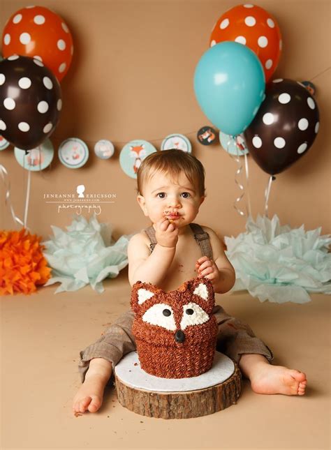 This giant cupcake iced with pretty flowers makes a sweet cake for a baby girl, and replaces the traditional pink with a glittery gold number 1 topper. Fox themed Cake smash brown and orange first birthday http ...