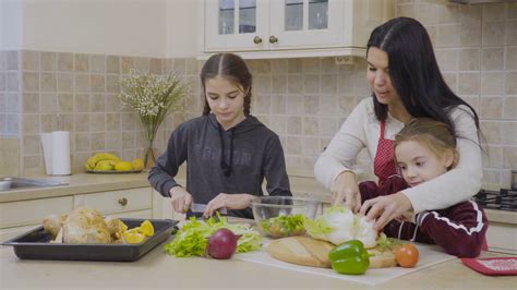 Daughters Help Mother To Cook The Dinner Stock Video Footage 0012 Sbv