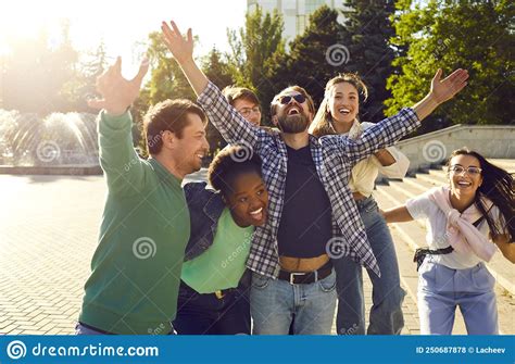 Cheerful Group Of Friends Have Fun Rejoice Laugh And Hug While