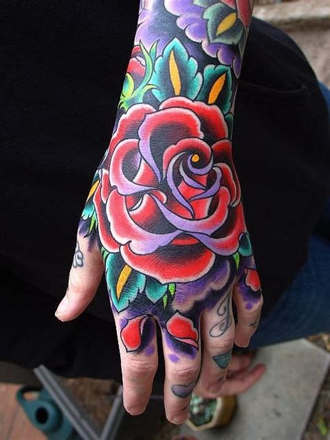 A red rose tattoo may symbolize love and passion, but it may also represent sacrifice or a reminder of romance. Traditional style rose tattoo on hand - Tattooimages.biz
