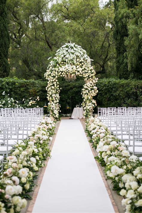 Consider stringing long pearl strands or crystal balls to hang on and in between each pew. 10 New Ideas for Wedding Ceremony Aisle Décor - Grand Central Floral
