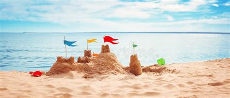 Sand Castle With Colourful Flags On The Beach Of The Sea Stock Image