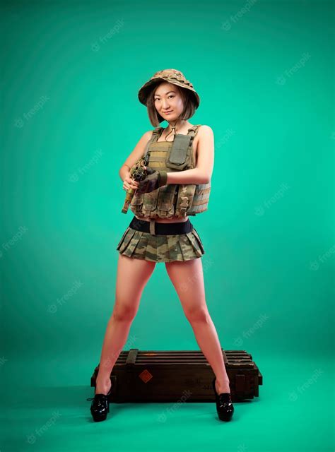 Premium Photo Sexy Asian Woman In Military Clothes With An Automatic Rifle In Her Hands While
