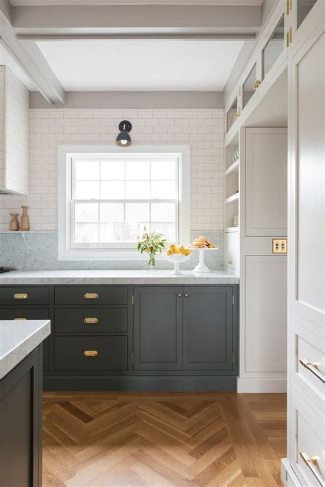 With countertops typically measuring 1 to 1 ½ inches in thickness, together the base cabinet and countertop will combine for a height of close to 36 inches, which is widely accepted as a standard countertop. Kitchen flush mount doors grey lower cabinetry white upper ...