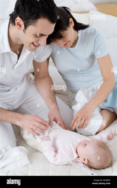 Parents Changing Their Babys Diaper Stock Photo Alamy