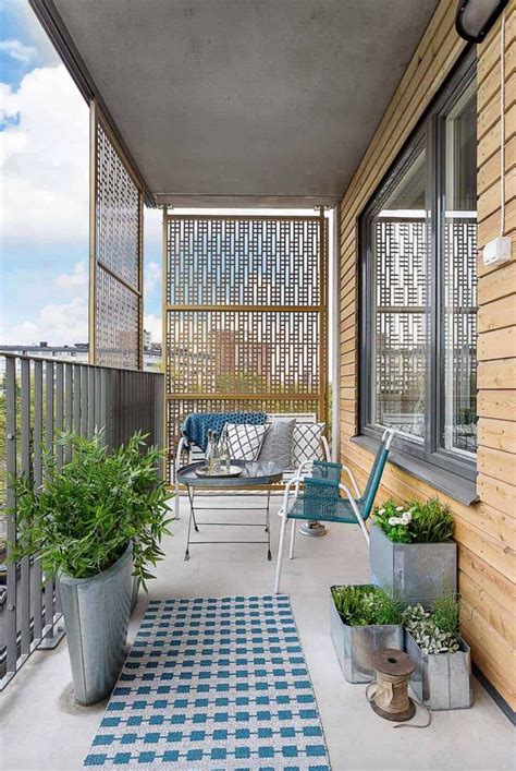 A Balcony With Potted Plants And Chairs On The Outside Patio Along