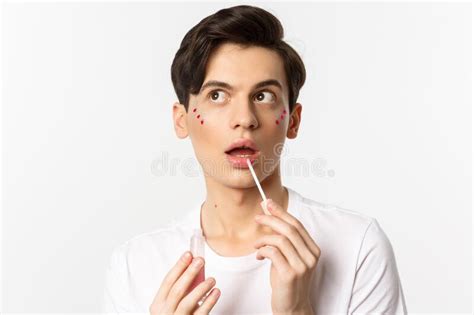 Close Up Of Beautiful Androgynous Man With Glitter Under Eyes Applying