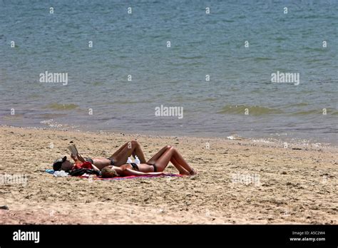 Visitors Sunbathe And Read On Beach Ko Jum Island Thailand Stock Photo