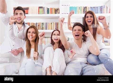 Cheerful Friends Watching Game On Tv Cheering Stock Photo Alamy