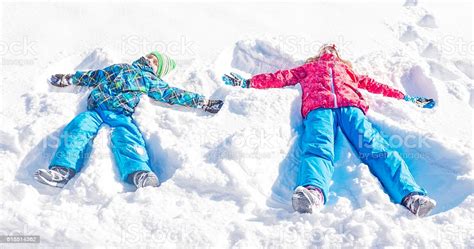 Children Making Snow Angels Stock Photo Download Image