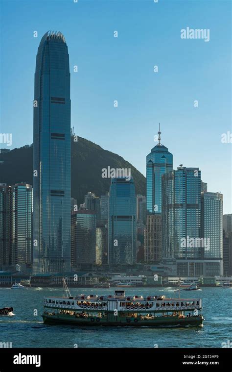 An Iconic Star Ferry Crosses Victoria Harbour In Front Of 2ifc And The