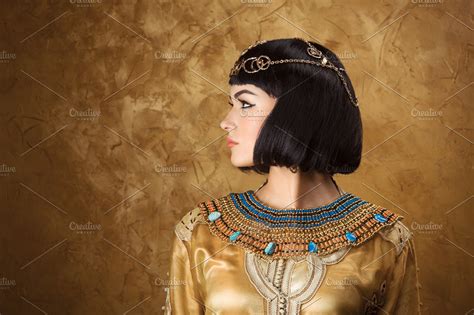 Beautiful Woman Like Egyptian Queen Cleopatra On Golden Background Side View Face Profile