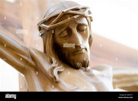 The Face Of Jesus Crucified On The Cross In A Wooden Statue Stock Photo