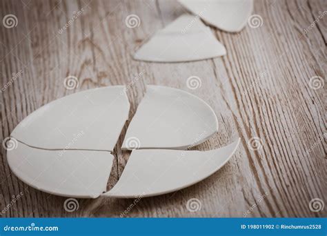 Broken Plate On The Floor In The Kitchen The Concept Of Accidents In