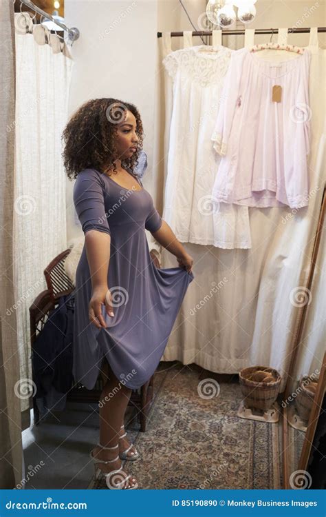 Woman Trying On Dress In A Boutique Changing Room Vertical Stock Photo Image Of Business