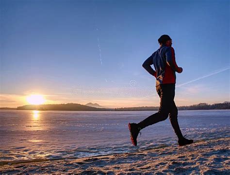 Running Or Jogging On Beach In Winter Sunny Day Morning Stock Photo