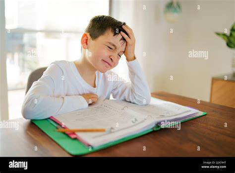 Thinking Child Bored And Frustrated And Fed Up Doing His Homework Stock