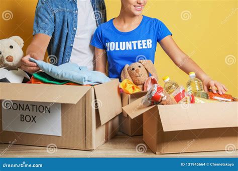 Young Volunteers Collecting Donations At Table Stock Photo Image Of