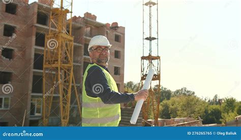 Male Engineer In Hardhat And Vest Regulating Work At Construction Stock