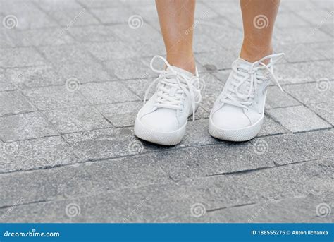 A Person Woman S Legs In Shoes Standing On A Sidewalk Stock Image