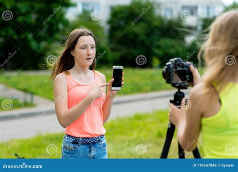 Two Girl Friends Summer Nature Writes Video Camera In Hands Holds Smartphone Concept Of