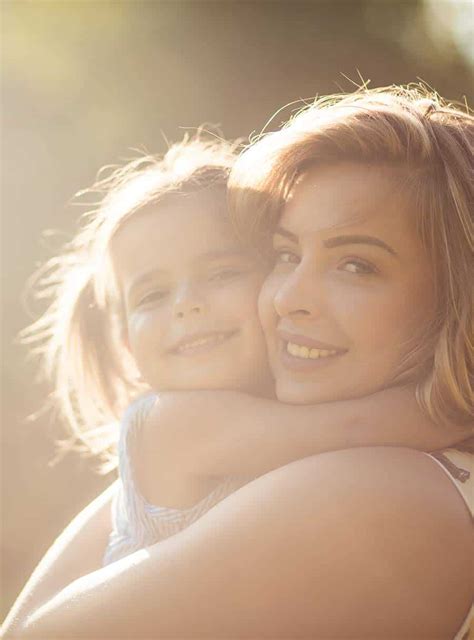 Mom Hugging Babe Sunlight Veritas Fertility Surgery