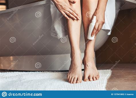 Female Legs Young Woman In The Bathroom Stroking Her Legs Stock