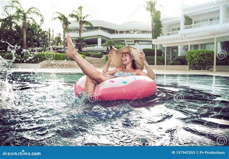 Summer Holiday By The Pool Woman Relaxes On An Inflatable Circle In
