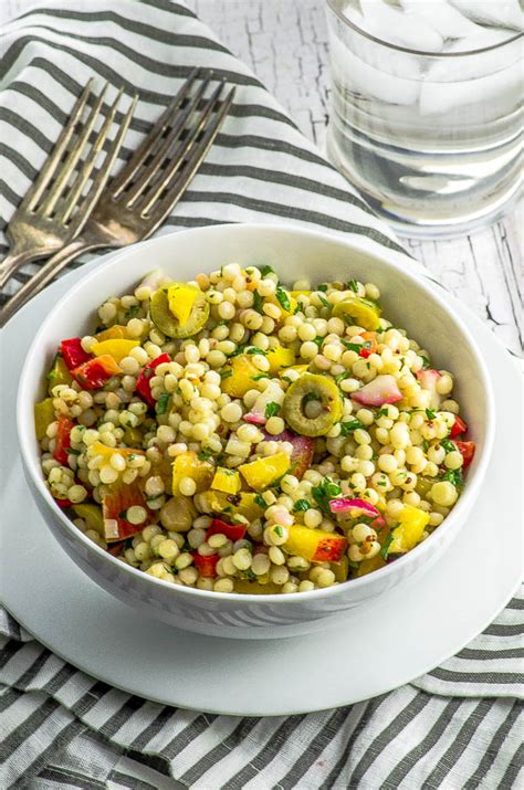 In a separate small bowl, combine the remaining olive oil, the lemon juice (2 tbsp lemon juice) and hummus (1 tbsp hummus (optional)), add to the couscous and stir until. Israeli Couscous Salad with Spicy Dressing - May I Have ...