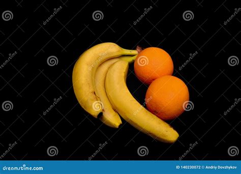 Bananas And Oranges Lie On A Black Tropical Fruit Stock Photo Image
