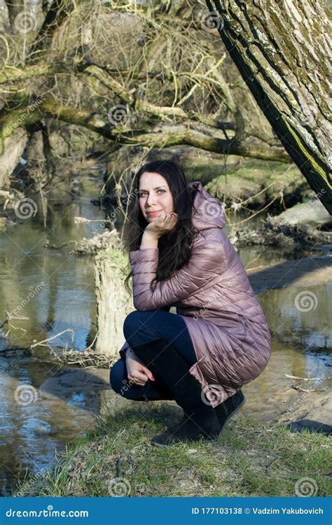 Girl In A Spring Park Squatting By The River Stock Photo Image Of Natural Happy
