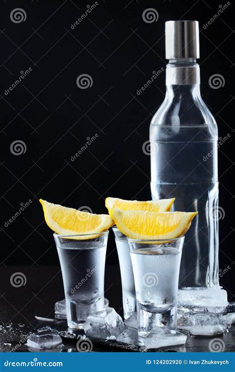 Vodka Shots Glasses With Vodka With Lemondark Stone Background