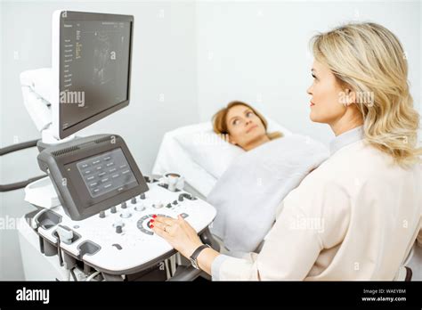 Female Doctor Performs Ultrasound Examination Of A Womens Pelvic Organs Or Diagnosing Early