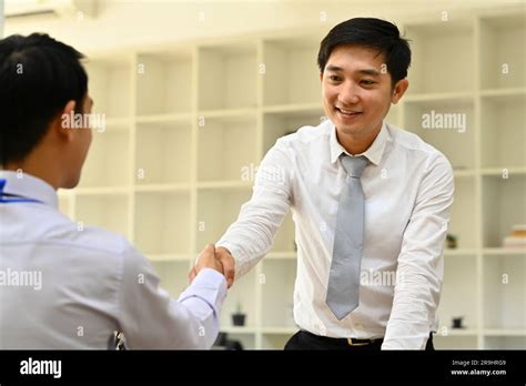 Millennial Entrepreneur Shaking Hands With Partner In The Office